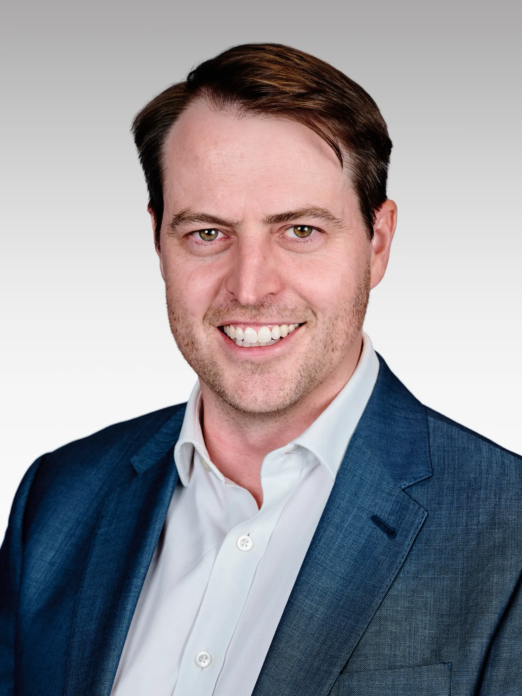 Corporate headshot of a male executive in a blue blazer, photographed in our Woodstock studio in Cape Town